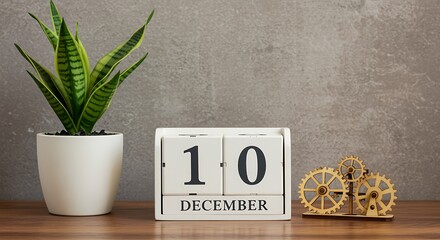 Wooden perpetual calendar showing december 10th with a plant and gears