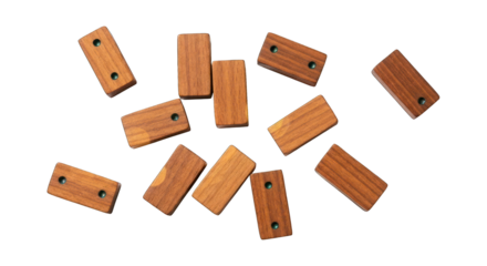 Scattered wood dominoes with metal dots on a stark black background