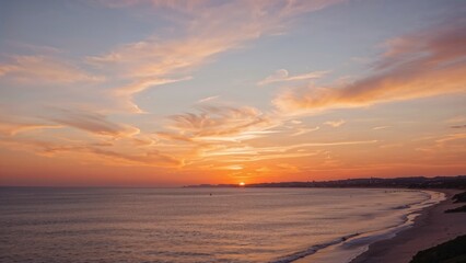 Sunset over the ocean at a beach with a colorful sky and clouds.