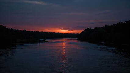Fototapeta premium River at sunset during twilight with colorful sky and silhouetted trees. Nature landscape image. Tranquil water scene. Calm evening environment with peaceful surroundings.