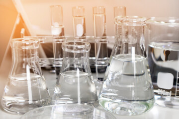 Clear bottles and dishes are used in scientific and medical experiments.
