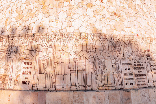 Merida, Yucatan, Mexico, Large wall with a drawing of people on it. The drawing is of people in the year 1887