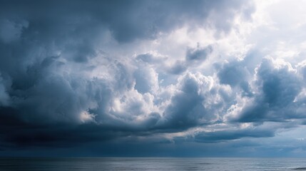 Landscape photograph of a stormy sky over the ocean. the sky is filled with dark, ominous clouds that are covering most of the sky.