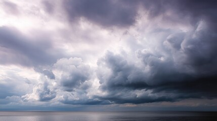 Landscape photograph of a stormy sky over the ocean. the sky is filled with dark, ominous clouds that are covering most of the entire sky.