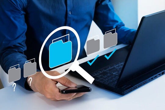 Business concept Businessman search for documents and check documents systematically and prioritize them to make the organization have an organized database.