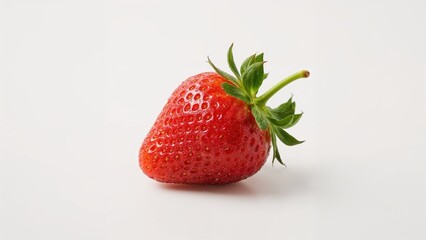 Close-up of a fresh strawberry with green leaves on a plain background.