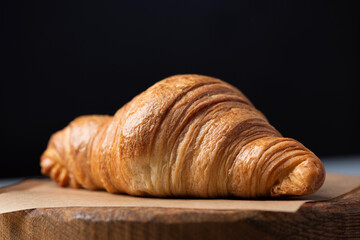 Delicious french croissant on wooden board