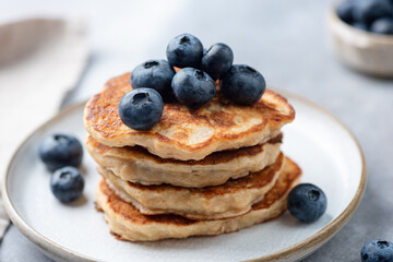 Stack of gluten free vegan oat pancakes with blueberries