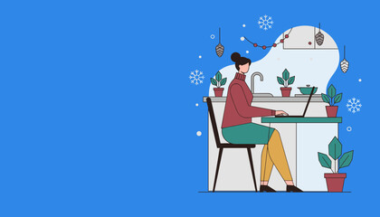 Woman working from home on her laptop in a cozy decorated kitchen during the winter season
