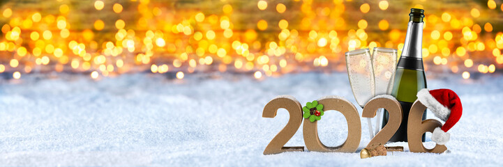 Festive scene showcases a champagne bottle and glasses next to sparkling lights and the year 2026, capturing the joyful spirit of a new year's celebration