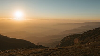 Fototapeta premium Sunrise over mountain ranges with morning fog and landscape. Nature and scenic view. The concept of sunrise and mountain scenery.