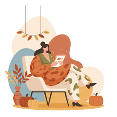 Cozy autumn scene Woman using tablet in armchair with pumpkins and fall decor