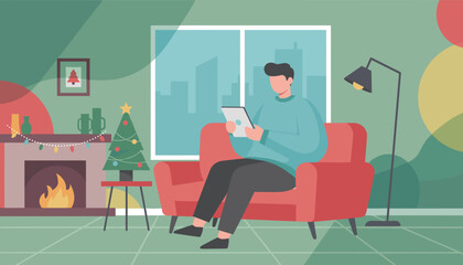 Relaxed man reading tablet by the fireplace in a cozy Christmas home interior