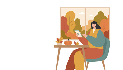 Woman controls smart device at home in autumn cozy interior scene with pumpkin decoration