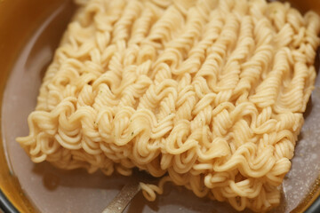 Cooked instant noodles with broth in a bowl