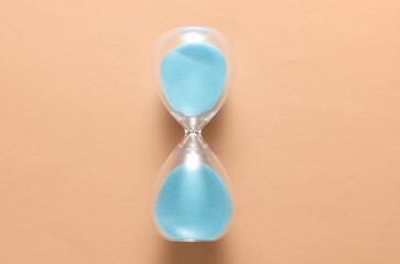 Glass Hourglass on a pink background. Top view