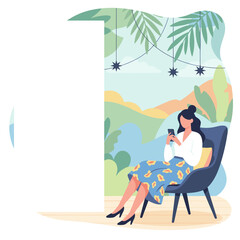 Woman uses phone in a modern outdoor lounge setting enjoying leisure time surrounded by nature