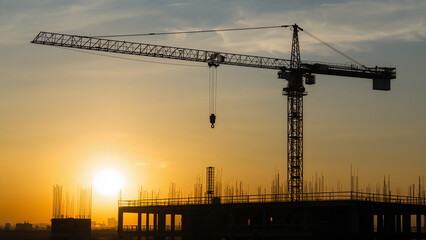 Construction Crane Silhouette Against Sunset Sky