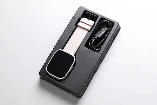 New smart bracelet with packaging on gray background