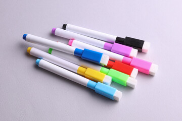 Set of colored markers on a gray background