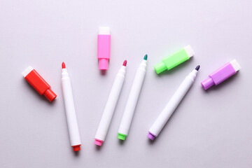 Set of colored markers on a gray background