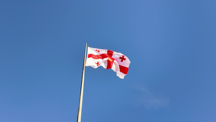 Georgian National Flag Fluttering Under Clear Summer Sky