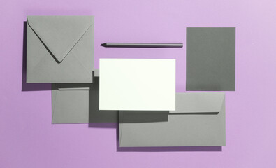 Floating envelopes with card on purple background with shadow. Minimalism, modern business still life, creative layout