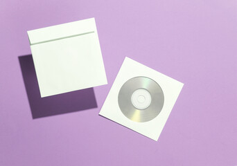 Mockup of CD discs in Paper packs on purple background