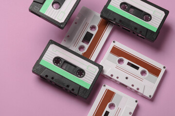 Floating retro 80s audio cassettes on pink background. Conceptual pop, creative layout. Minimalism