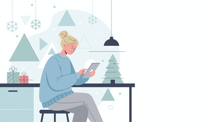 Woman sits with a tablet in a cozy modern winter setting surrounded by gifts