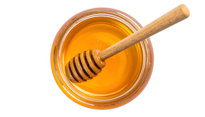Overhead shot of a clear glass jar filled with amber honey, a wooden dipper inside