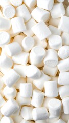 A dense, overhead view of white, pillowy marshmallows