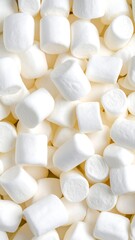 A dense pile of fluffy, white marshmallows with a soft texture, filling the frame