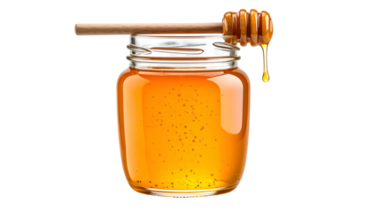 A glass jar filled with golden honey, a wooden dipper resting on top with a dripping droplet