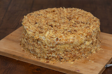 Homemade Layered Puff Pastry Cake on Wooden Table in Kitchen