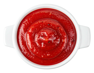 Close-up overhead shot of tomato-based condiment swirling inside a small white bowl