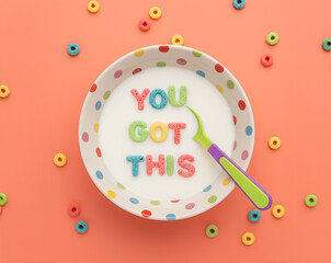 Naklejka premium “You Got This” Cereal Letters in Milk Bowl on Peach Background