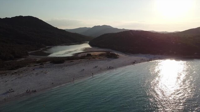 Aerial view of Barcaggio beach and coastline at sunset, northern Corsica, France.