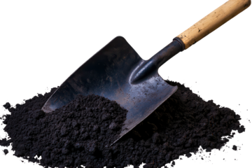 Shiny metal shovel embedded in dark soil ready for gardening tasks in a backyard setting