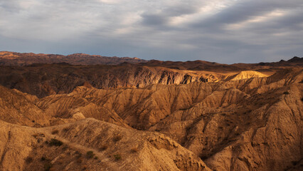 Golden Kazakh steppes contrast with red-rock canyons and labyrinthine cliff formations