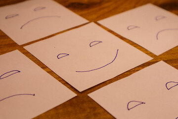 Happy face drawing among sad faces concept of positivity