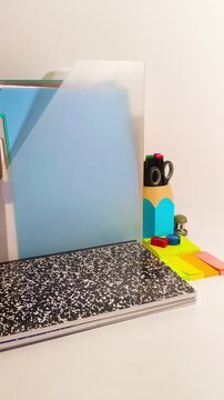 Creative workspace showing scattered school supplies, notebooks, and colorful stationery. A dynamic background for back-to-school promos and educational content creation