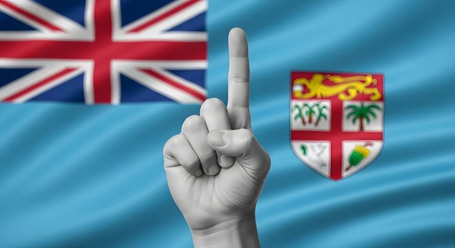 Hand with raised index finger in front of the flag of Fiji.