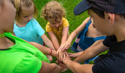 Fototapeta premium The children put their hands together. Selective focus.