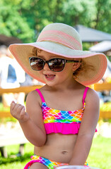 Child in a hat and sunglasses. Selective focus.