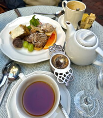 Warm and inviting café scene with tea, dessert, and tableware captured in natural light. A cozy setting for a relaxing afternoon in Boston, Massachusetts.