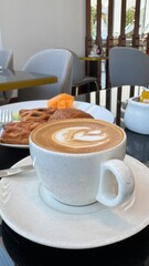 table setting in restaurant golden-brown croissant and a cup of coffee on a wooden table in a cafe