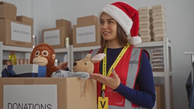 Woman organizing donations at charity center wearing santa hat sorting toys in festive indoor setting enhancing volunteer spirit and holiday joy helping community with generous contributions.