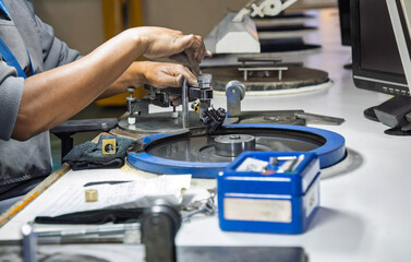 diamond polisher at work, using a polishing wheel to shape and refine a rough diamond. This process, brillianteering , is the final stage of diamond cutting.
