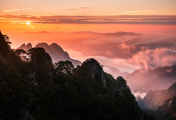 sunrise in the Huangshan Yellow Mountains in China  with fog rising